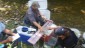 Processing fish along the shore of the Beatty Saugeen River